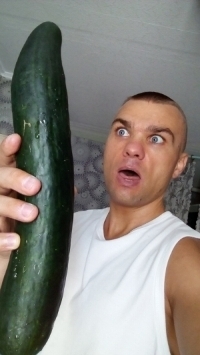 Man with a huge cucumber